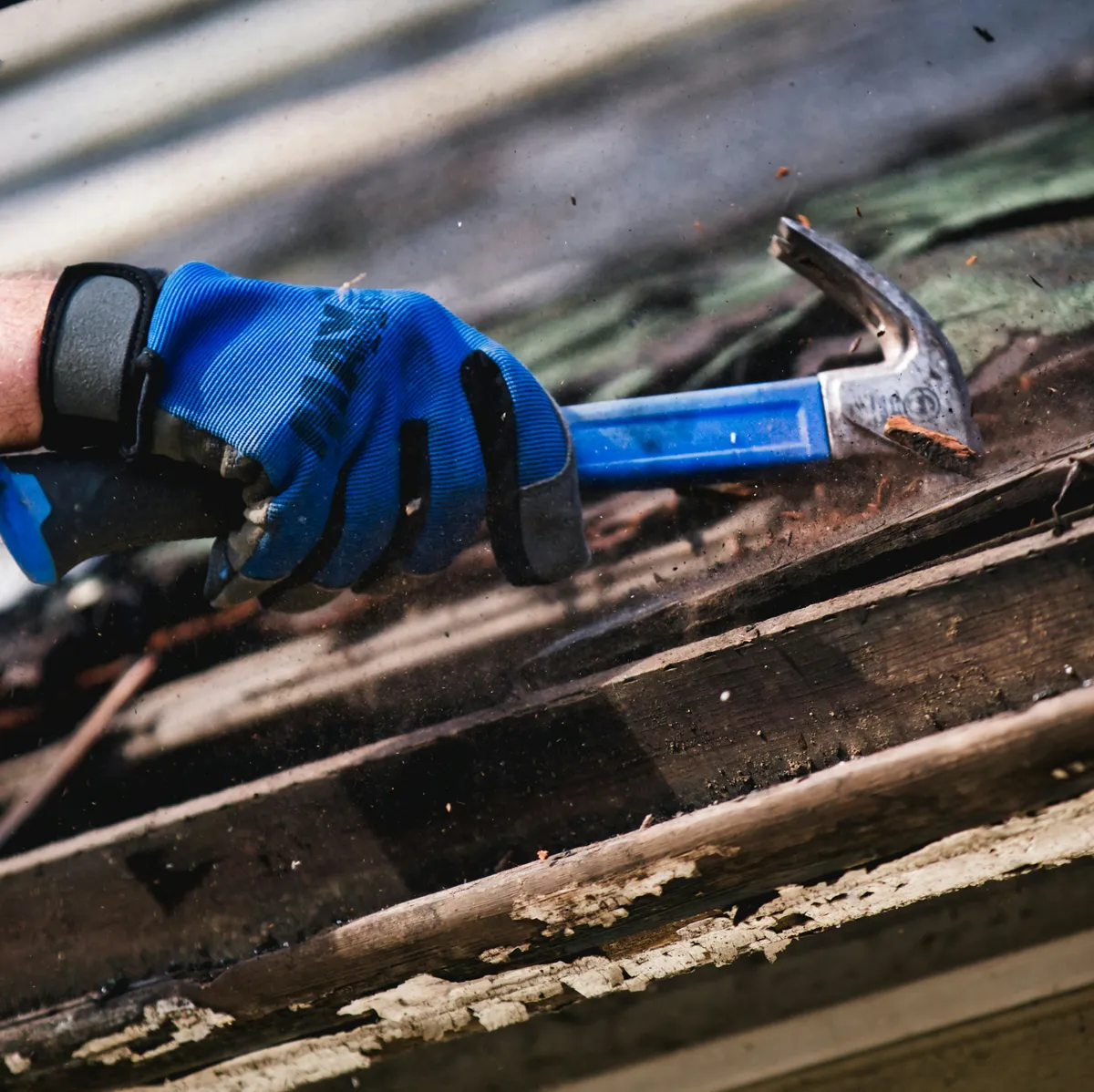 Hammer pulling nails on a roof repair